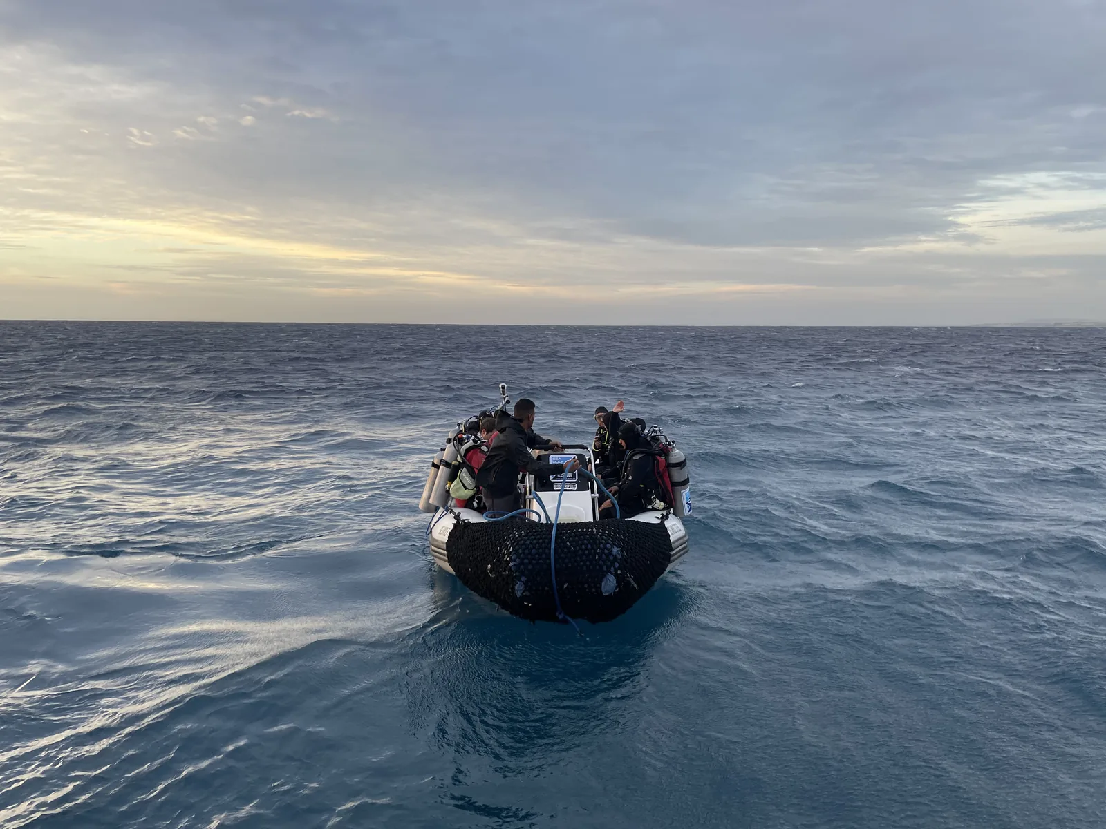 Schlauchboot mit Tauchern im Morgengrauen auf dem offenen Roten Meer
